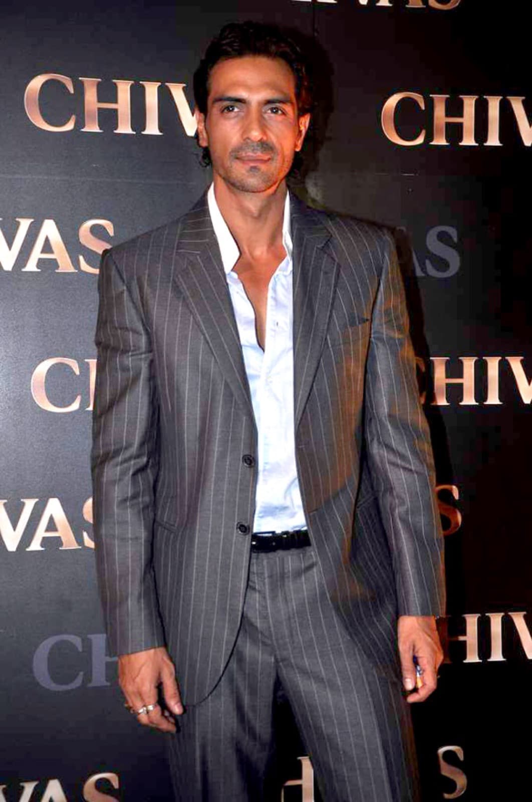 Arjun Rampal in a grey pinstripe suit at an event