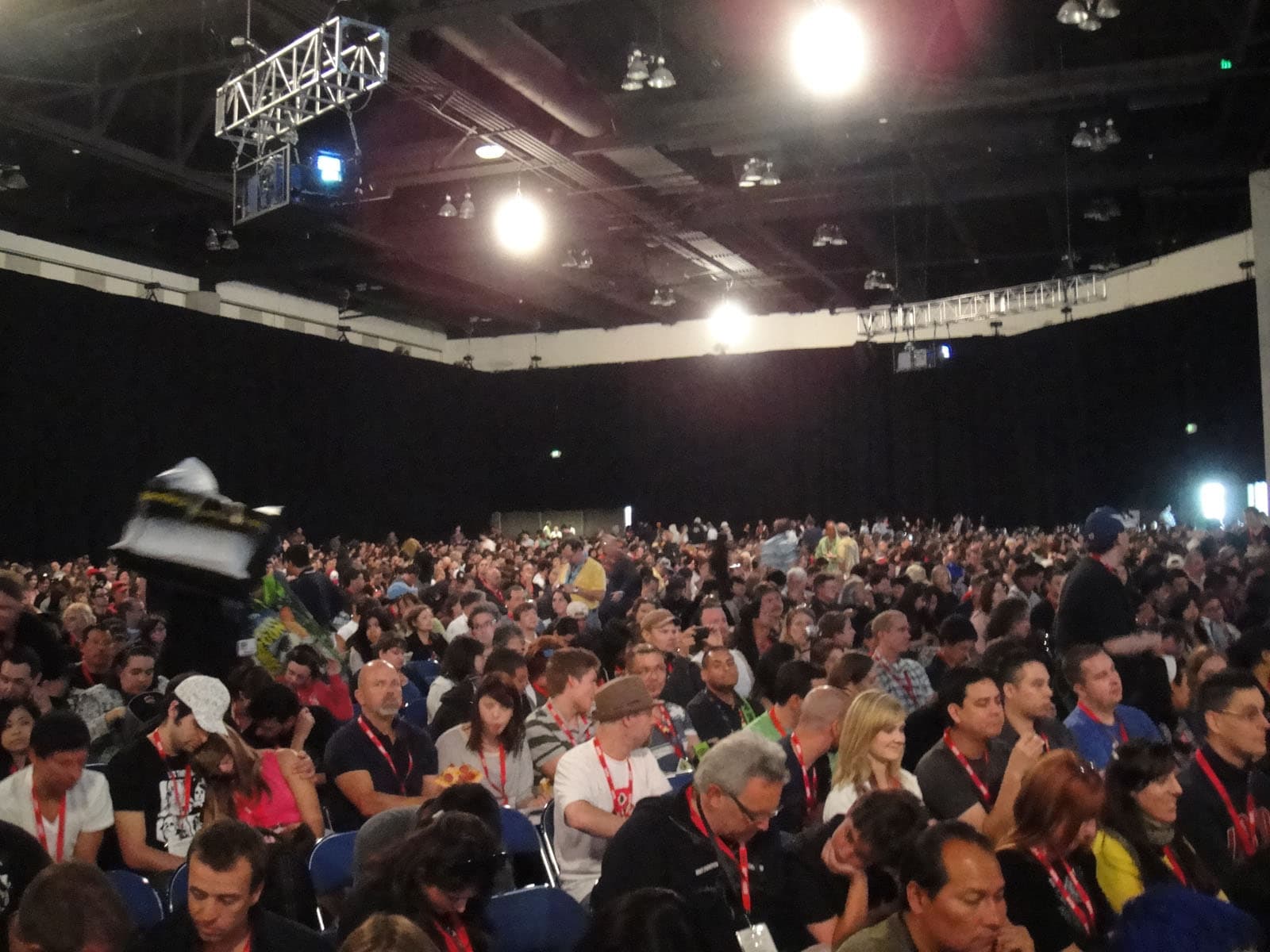 Thousands of badge-wearing attendees seated inside the darkened Hall H at Comic-Con