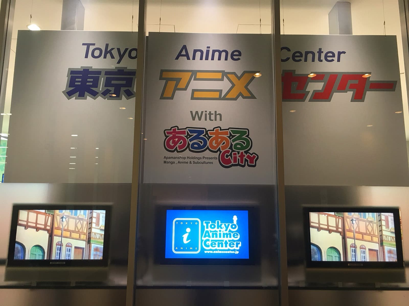 Signboards reading Tokyo Anime Center in English and Japanese above display screens